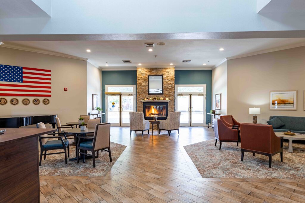 Inspirations of River Centre welcome area with comfortable seating, fireplace, and access to the exterior courtyard.